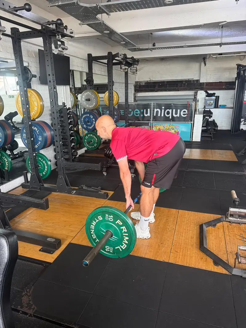 A member setting up a deadlift on the lifting platform